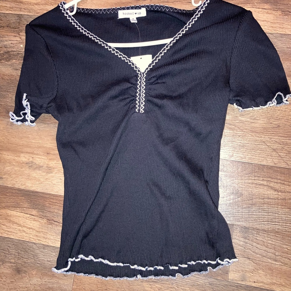 Brand new shirt. Embroidered neck line and lettuce hem.
